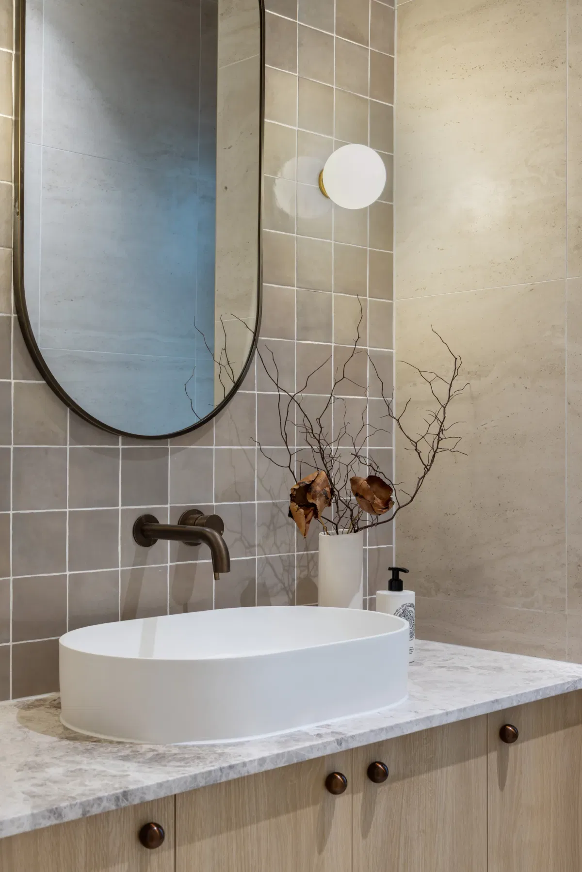 Pale timber bathroom vanity and oval mirror from Saba's portfolio